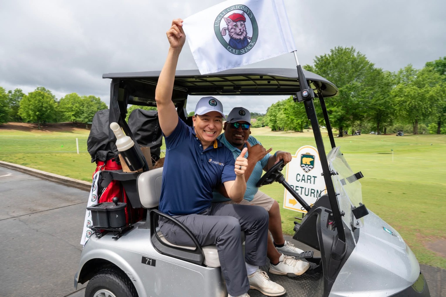 Golfers with an Uncle Grigsby tournament flag